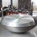 A Town aluminum wok cover on a large metal wok.
