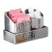 A silver American Metalcraft hammered stainless steel square sugar caddy with sugar packets and sugar cubes.