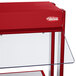 A red Hatco countertop buffet warmer with a glass top over warmers.