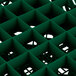 A close up of a green plastic grid with squares.