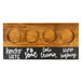 A Cal-Mil Madera natural wooden flight tray with circles and white writing on it.