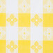 A yellow and white checkered tablecloth with a flower design.