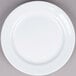 A Tuxton Alaska bright white china plate with a wide rolled edge.