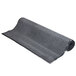 A roll of charcoal entrance mat on a white background.