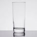 An Arcoroc clear beverage glass on a table.