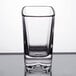 A close-up of a clear Arcoroc tall square shot glass.
