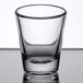 An Arcoroc shot glass with clear glass on a table.