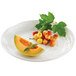 A Tablecraft white round pebbled melamine tray with a melon and berries on it.