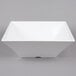 A white square Tablecraft melamine bowl with a lid.