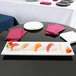 A white rectangular Tablecraft Melamine tray with sushi on it.