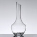 A clear glass decanter with a curved base.