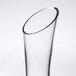 A clear glass vase with a curved rim.