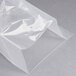 A clear plastic bag of ARY VacMaster chamber vacuum packaging pouches on a gray surface.