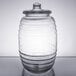 A clear Libbey barrel jar with a lid.