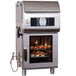 A large Alto-Shaam stainless steel ventless combi oven with food inside.