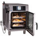 An Alto-Shaam Combitherm CT Express electric combi oven with food cooking inside.