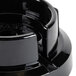 A black plastic Waring blender jar adapter.