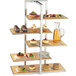 A Cal-Mil bamboo multi-level shelf display with desserts on it.