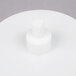 A white plastic discharge plate with a hexagon on top.
