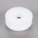A white plastic threaded actuator knob with a gold screw.