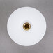 A white disc with a gold threaded center.
