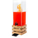 A Cal-Mil bamboo beverage dispenser with red liquid and oranges in it.