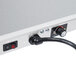 A close-up of a Hatco Glo-Ray heated shelf with a power cord.