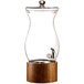 An American Atelier glass beverage dispenser with a wood base and tap.
