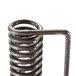 A close-up of a metal spring with a metal handle.