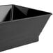 A black metal rectangular serving basket with a triangular design on the sides.