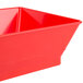 A red plastic triangle-shaped serving basket with a square base.