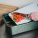 A hand using a knife to chop tomatoes on a green cutting board in a HS Inc. Jalapeno Prep n Serve Deep Tote.