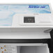 A white Turbo Air ice merchandiser with a digital display.
