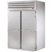 A large stainless steel True 2 section roll-in refrigerator with solid doors.