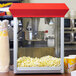A Carnival King popcorn machine with popcorn in it.