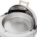 A Vollrath stainless steel round chafer with brass trim and a lid.
