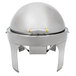 A Vollrath stainless steel round chafing dish with brass trim and a metal lid.
