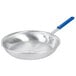 A close-up of a Vollrath Wear-Ever aluminum fry pan with a blue handle.