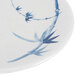 A close-up of a white melamine plate with blue bamboo design.