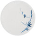 A white plate with blue painted bamboo design.