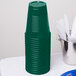 A stack of hunter green plastic cups.