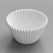 A white fluted baking cup on a white surface.
