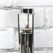 A metal lantern with a Sterno Soft Light liquid candle inside.
