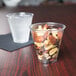A Solo Ultra Clear plastic cup filled with nuts and dried fruit on a table.