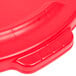 A red plastic lid for a Rubbermaid BRUTE trash can with a handle.