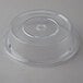 A clear plastic round lid with a hole on a table.