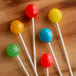 A group of Paper Lollipop Sticks with yellow, red, and four other colored lollipops.