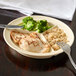 A Carlisle tan melamine 3-compartment plate with rice, broccoli, and chicken on it.
