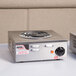 A APW Wyott portable electric hot plate with a single round burner on a metal square object.