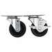 A set of four Beverage-Air metal plate casters with black rubber wheels.